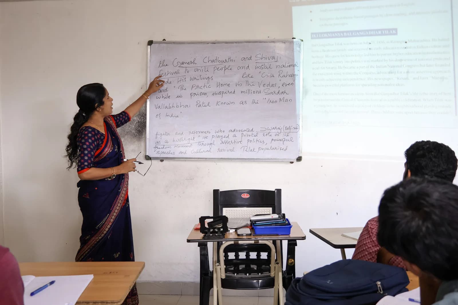 Teacher explaining a lesson at the whiteboard