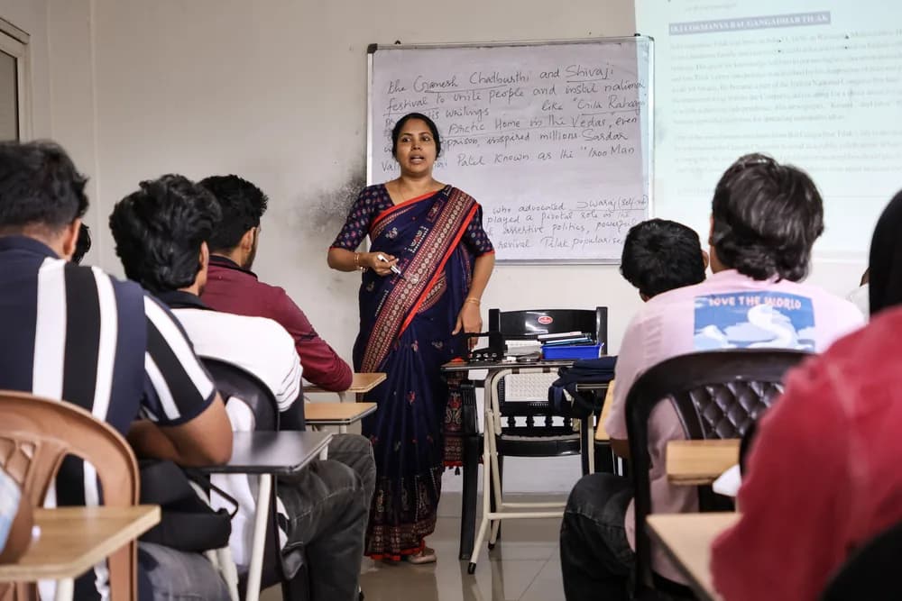 Teacher guiding students at a classroom board