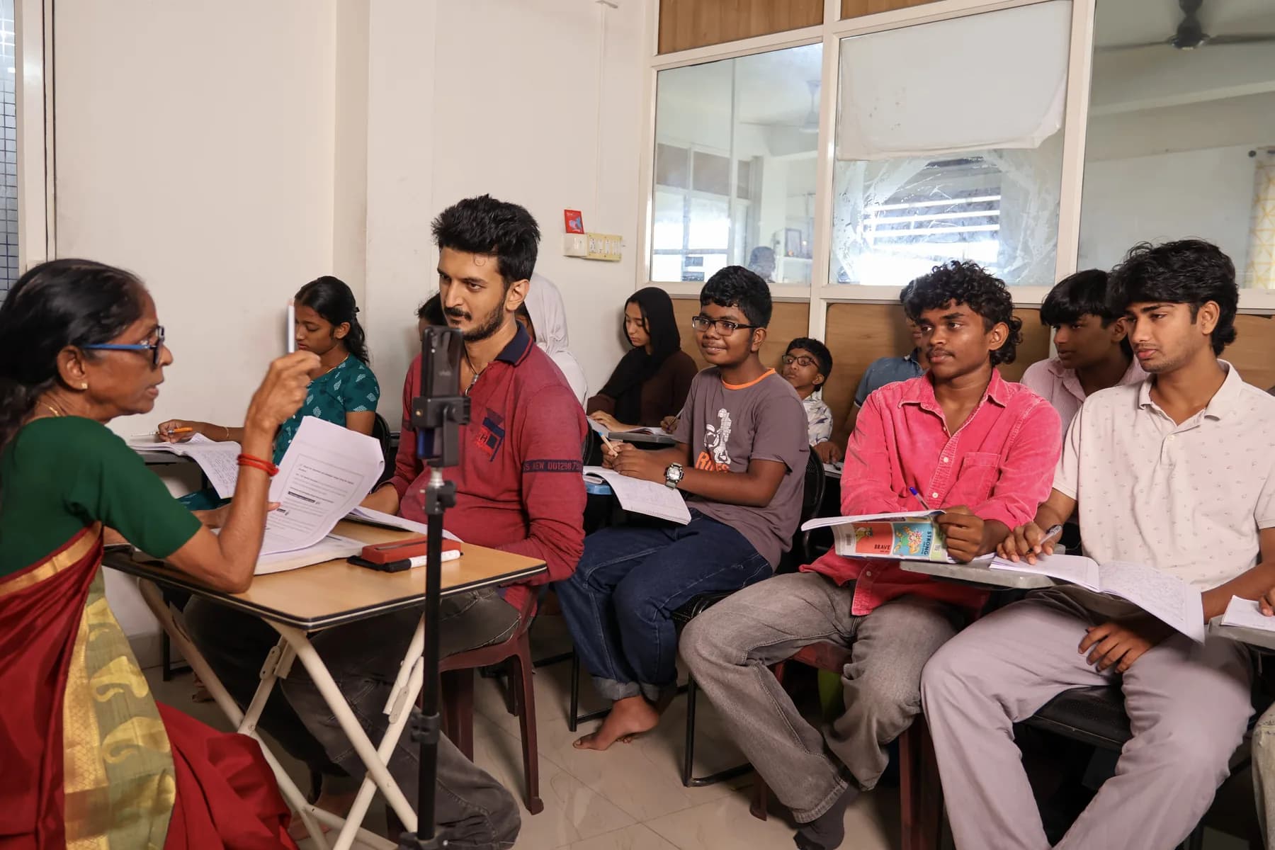 Vizioni teacher guiding Class 12 learners in a group session